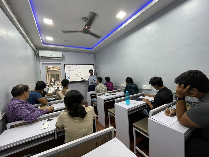 A trainer explaining a chart on the whiteboard