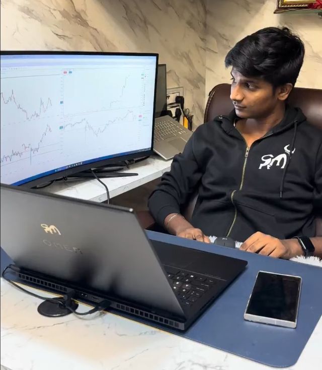 Sujal Patil at his trading desk with charts on screen